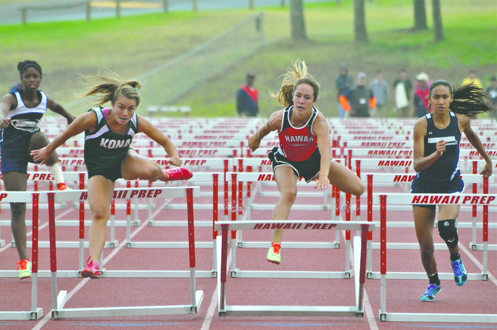 JARED FUJISAKI photo While leading, Konawaena's Ua Ruedy hits the last hurdle during the 100-meter race, as does Hawaii Prep's Emma Taylor, on Saturday at the BIIF track and field championships. ...