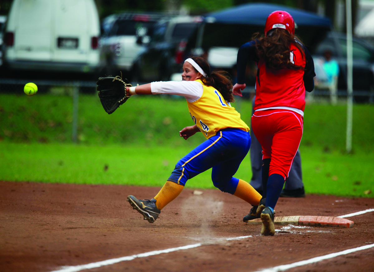 HOLLYN JOHNSON/Tribune-Herald  Hilo’s Caitlin Price records a putout Saturday as Keaau’s Cynthia Nakaima runs to first in the BIIF Division I softball title game.