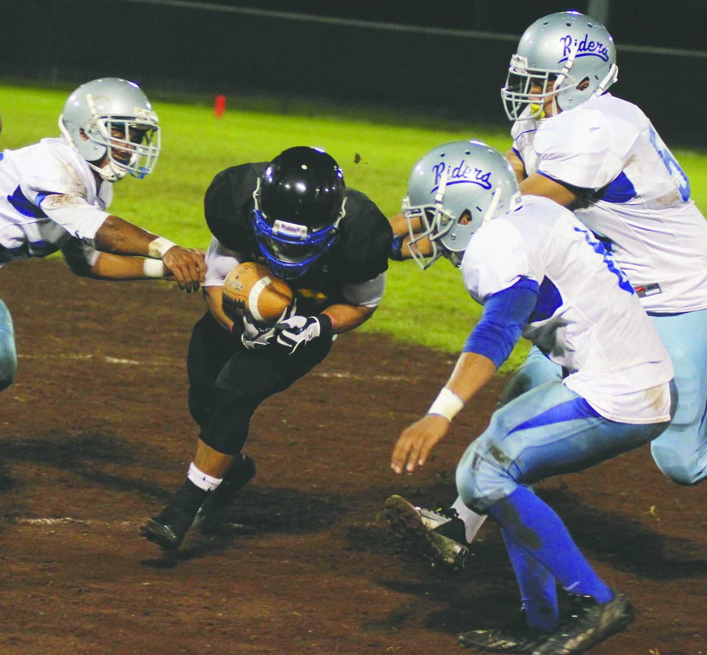 TIM WRIGHT/Tribune-Herald Hilo's Aven Kualii tries to gain yardage as Kealakehe's defense encircles him during the Vikings' 6-3 victory at Wong Stadium.