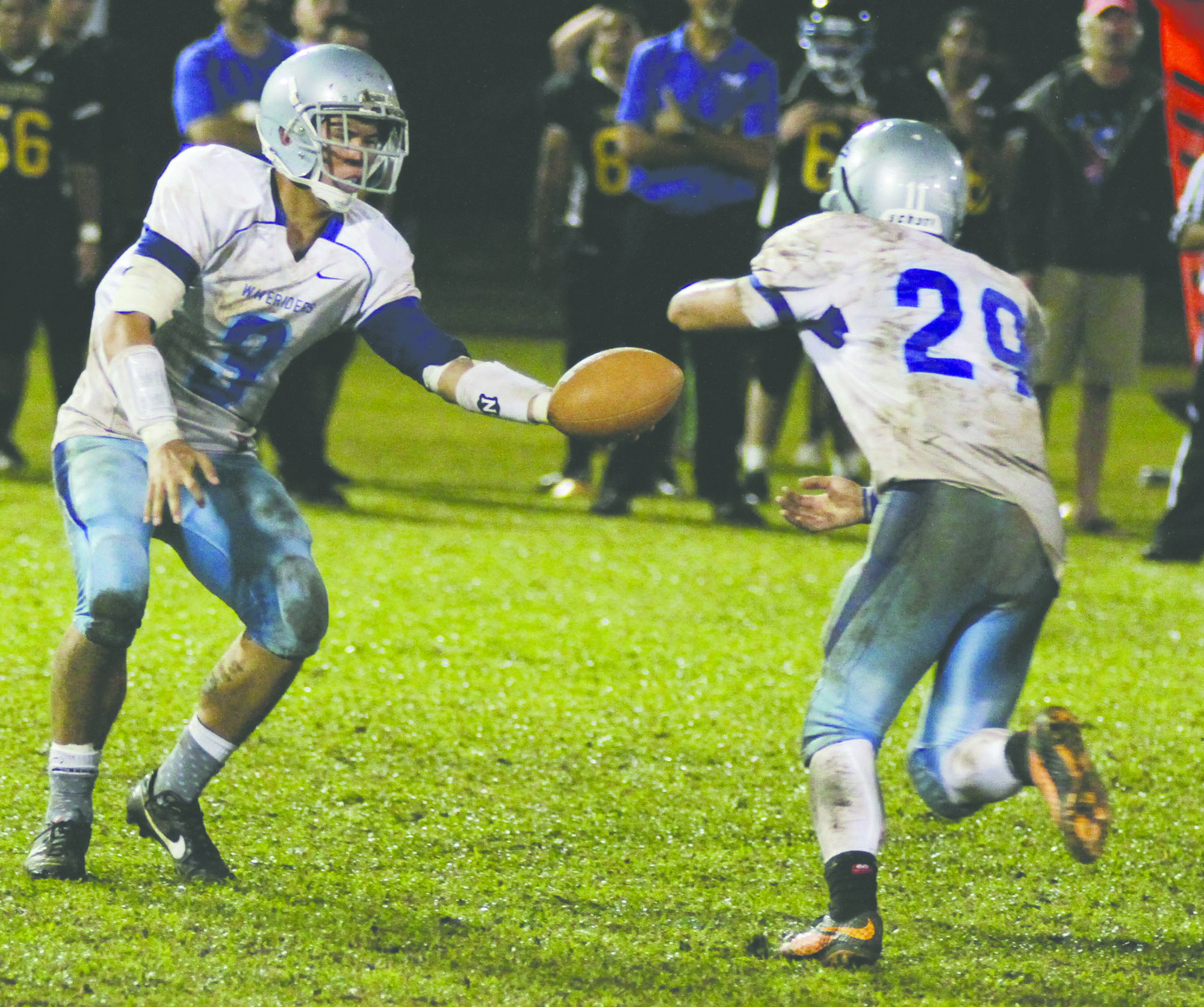 TIM WRIGHT/Tribune-Herald Kealakehe's Daniel Weber hands off to Keoni Yates on Saturday night during the Vikings' 6-3 victory.