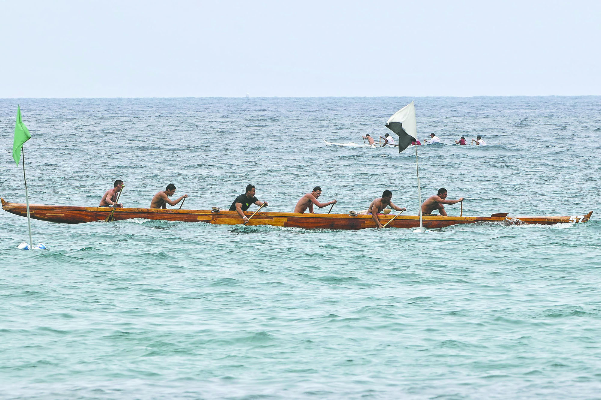 BRAD BALLESTEROS/Stephens Media Puna Canoe Club's boys 18 crew wins its 1-mile race Saturday during the Founders Regatta in Kailua Bay.