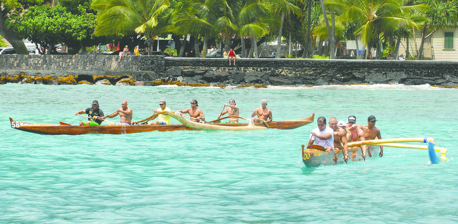 LAURA SHIMABUKU/Stephens Media Keauhou's men's masters team, left, crosses the finish line ahead of Keaukaha Canoe Club on Saturday at the Kamehameha Day Regatta at Kailua Bay.