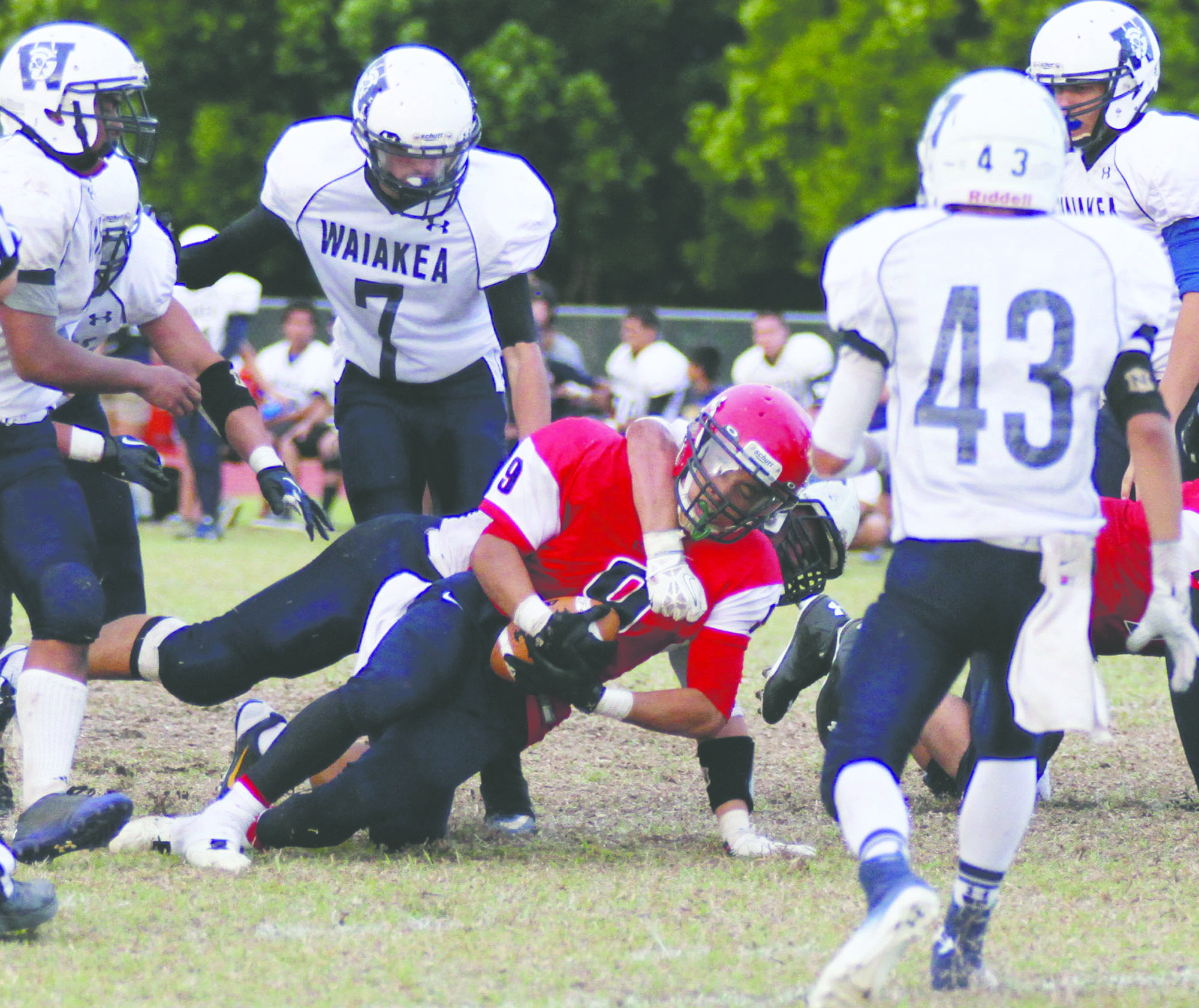 TIM WRIGHT/Tribune-Herald The Waiakea defense stops Keaau's Richard Hatori-Kanakaole on Saturday during the Warriors' 13-