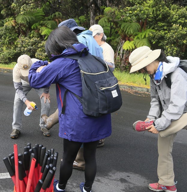 3598887_web1_Hikers-spray-boots-with-alcohol-before-entering-forest.jpg